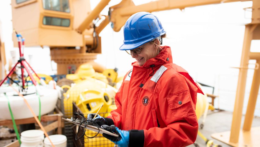New GMRI Chief Scientific Officer Janet Duffy-Anderson taking notes aboard a research vessel.