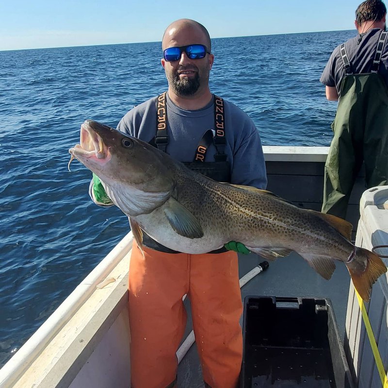 A man holding a big fish.