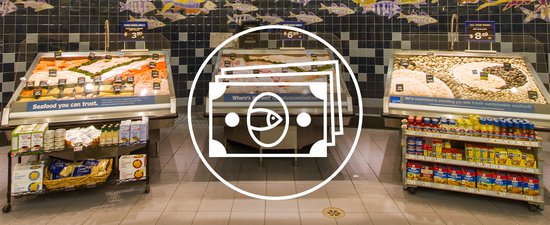 This image shows a white circle with a white outline of bills inside centered over a seafood section of a grocery store.