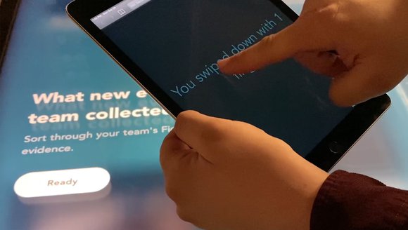 This image is a close up of a student using a tablet designed for students with disabilities to interact with LabVenture features.