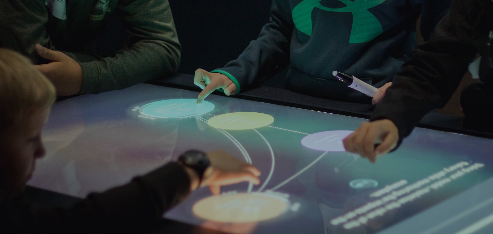 Students working with an interactive touch screen