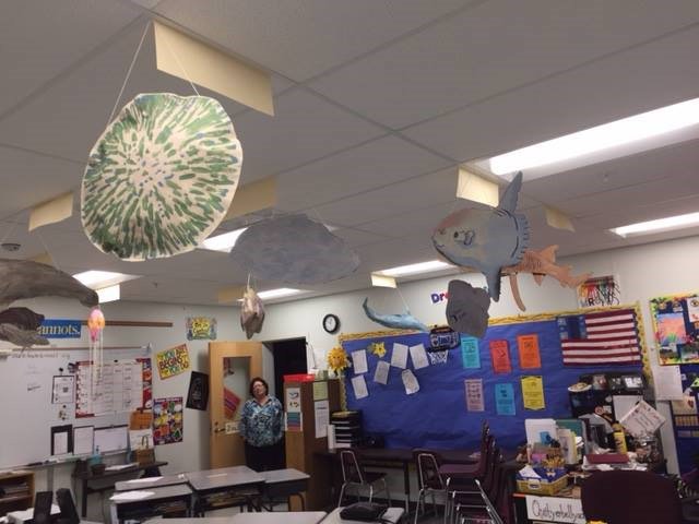 Students make colorful paper 3D models of their species to hang from the classroom ceiling