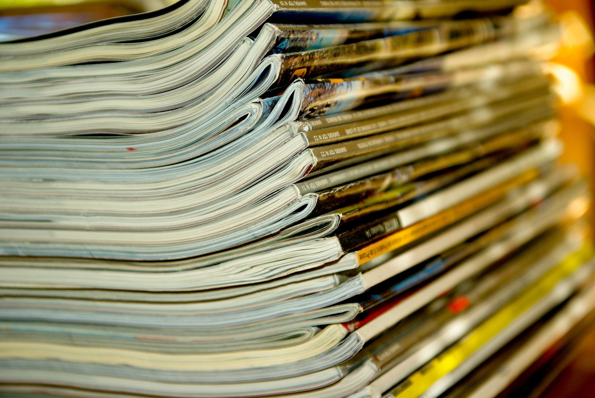 A close up shot of a stack of magazines and journals