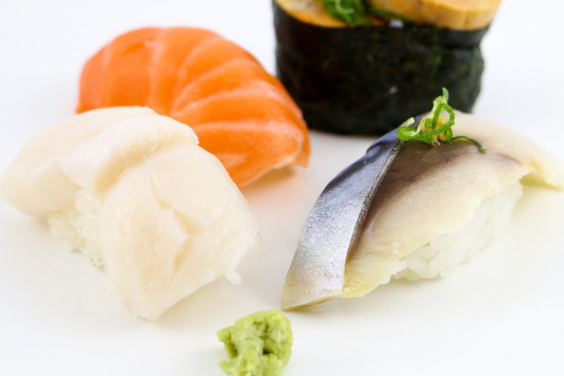 This image shows sushi up close sitting on a white table.